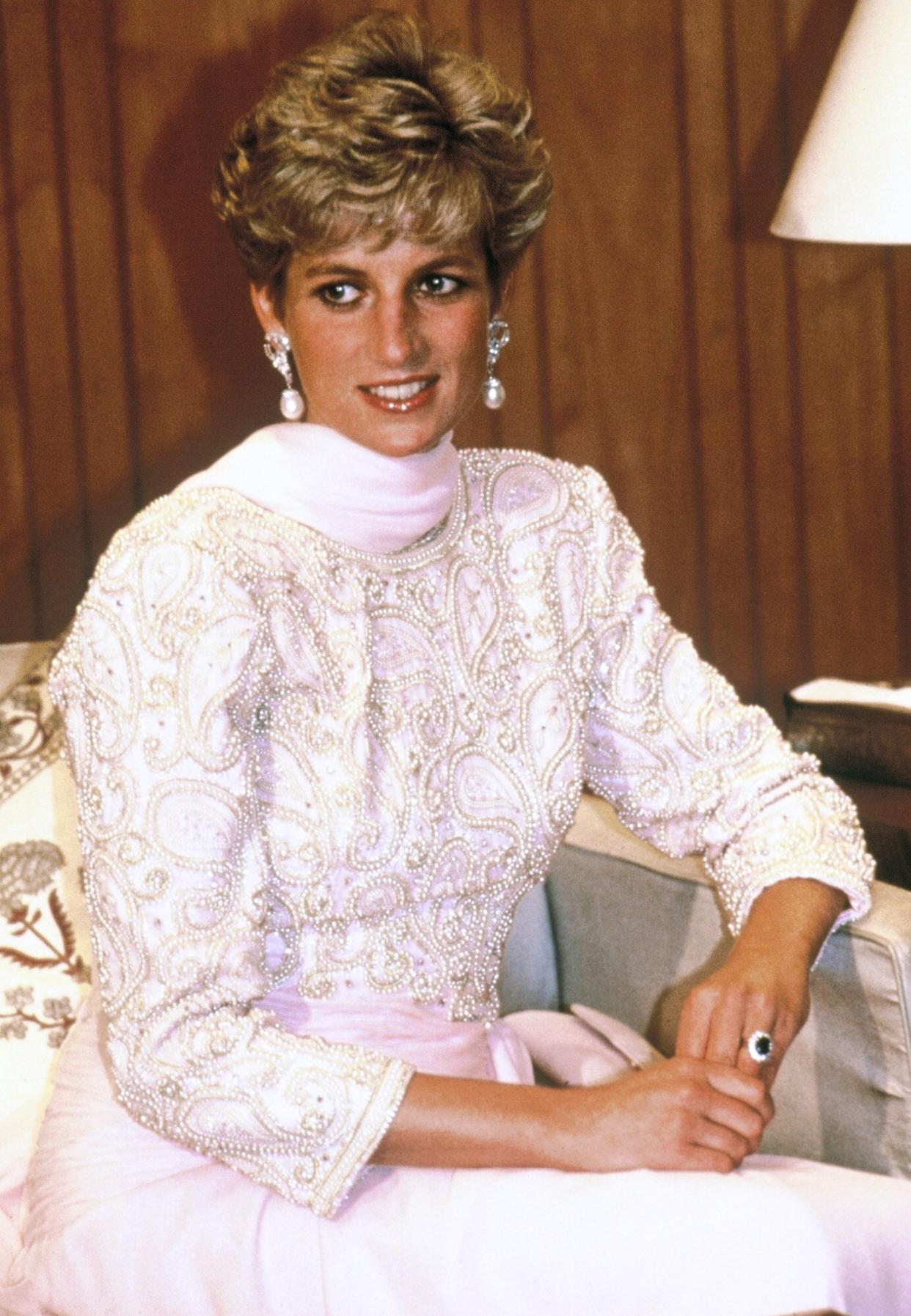 Diana, Princess of Wales, wearing a beaded evening gown with a pink chiffon sarong style detail designed by Catherine Walker, attends a dinner hosted by Pakistani President Ghulam Ishaq Khan on September 25, 1991 in Islamabad, Pakistan.