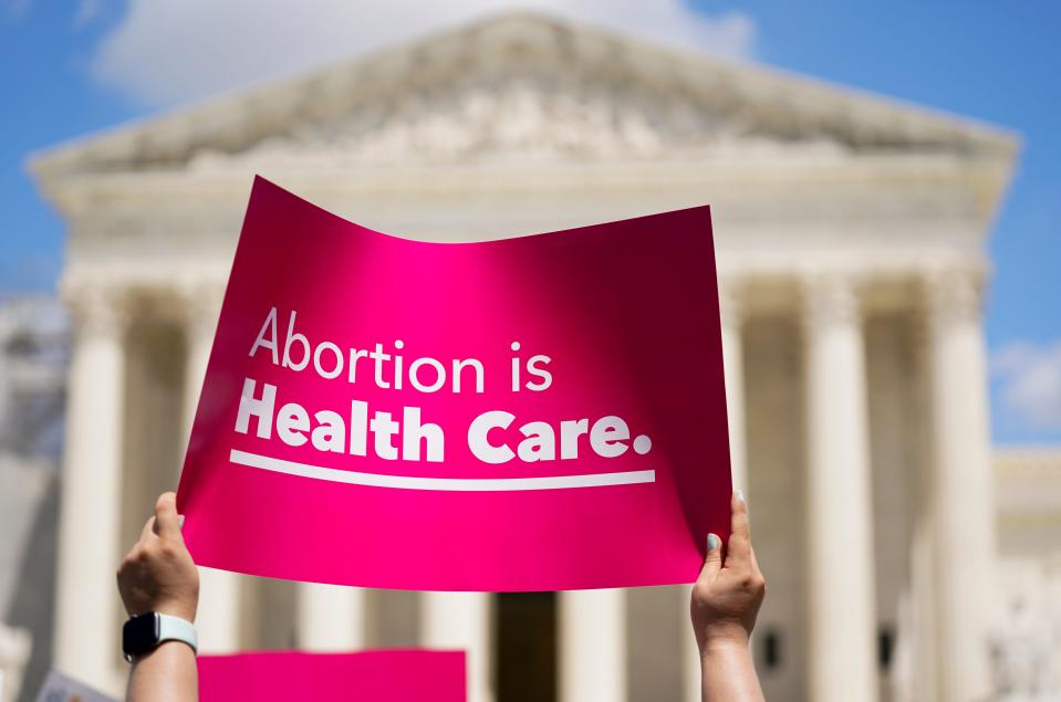 Demonstrators hold signs as they rally outside the Supreme Court building during the Women's March in Washington, Saturday, June 24, 2023.