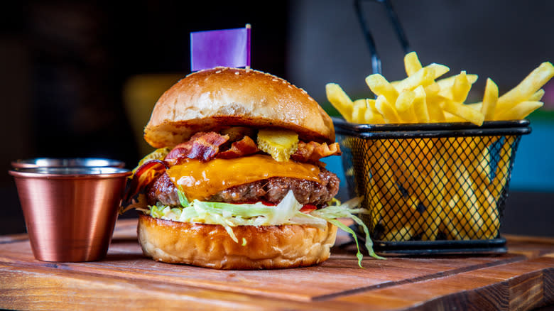 Loaded burger, fries, and ramekin