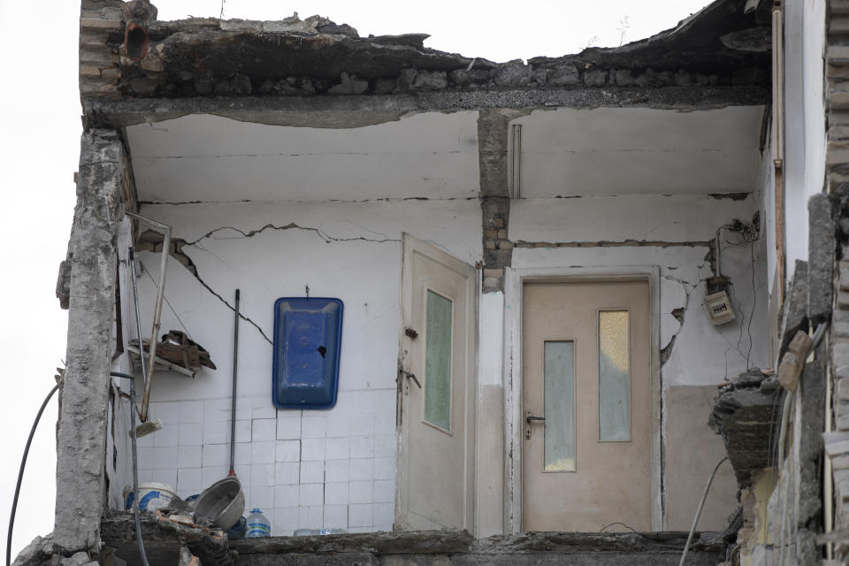 In this Wednesday, Nov. 27, 2019 photo a part of a collapsed building stands in Thumane, western Albania following a deadly earthquake. The 6.4-magnitude quake that hit Albania's Adriatic coast before dawn on Tuesday has left at least 51 people dead, around 2,000 others injured and about 4,000 people homeless. (AP Photo/Petros Giannakouris)