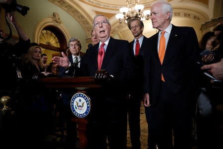 Senate Majority Leader Mitch McConnell, accompanied by Sen. John Cornyn (R-TX), Sen. John Thune (R-SD), Sen. John Barrasso (R-WY) and Sen. Cory Gardner (R-CO), speaks with reporters following the party luncheons on Capitol Hill in Washington, U.S. January 23, 2018. REUTERS/Aaron P. Bernstein