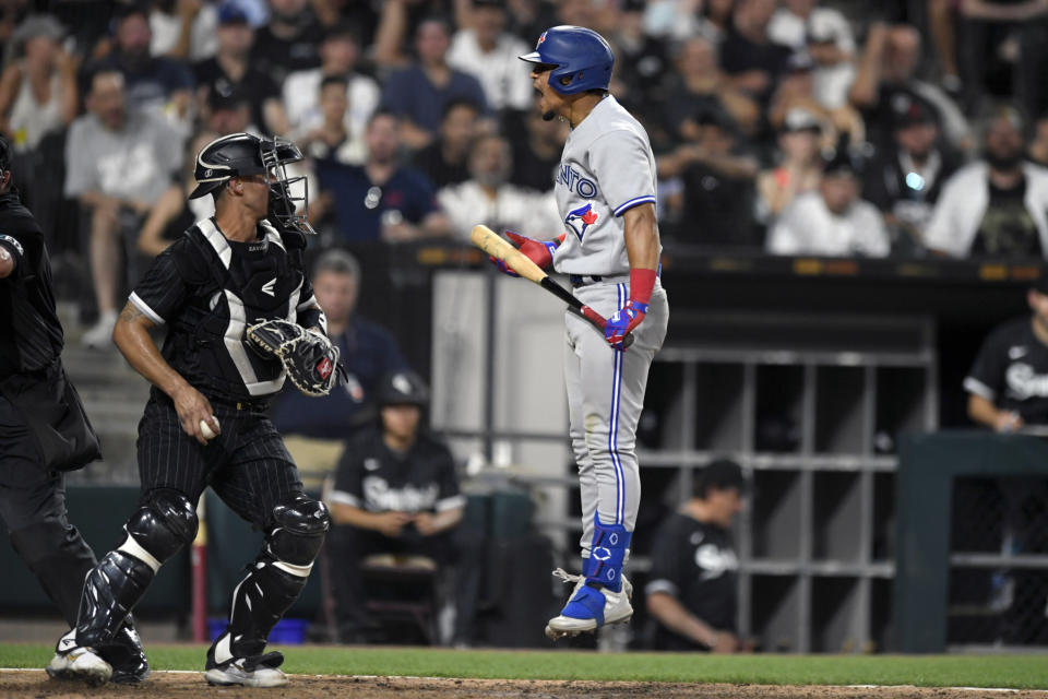Toronto Blue Jays' Santiago Espinal right, reacts after striking out while Chicago White Sox catcher Seby Zavala left, looks on during the seventh inning of a baseball game Tuesday, June 21, 2022, in Chicago. (AP Photo/Paul Beaty)