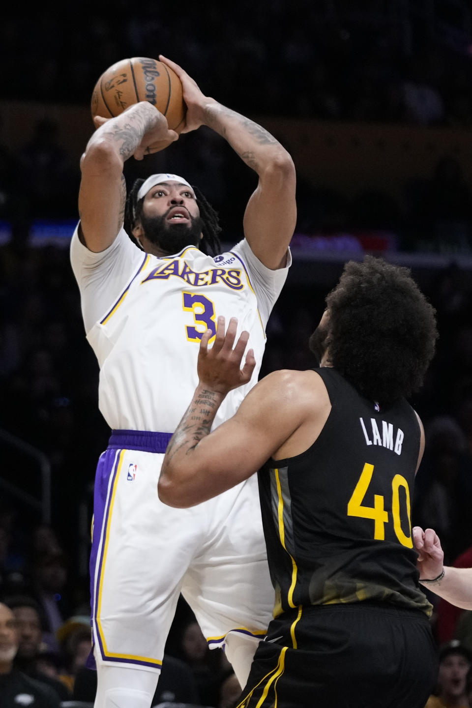 Los Angeles Lakers' Anthony Davis (3) shoots under defense by Golden State Warriors' Anthony Lamb (40) during the first half of an NBA basketball game, Sunday, March 5, 2023, in Los Angeles. (AP Photo/Jae C. Hong)