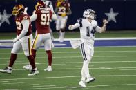 Dallas Cowboys quarterback Andy Dalton (14) gestures after throwing an incomplete pass into the end zone as Washington Football Team's Tim Settle (97) and Ryan Kerrigan (91) walk past in the second half of an NFL football game in Arlington, Texas, Thursday, Nov. 26, 2020. (AP Photo/Roger Steinman)