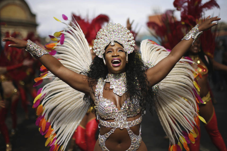 <p>Costumed revellers perform in the parade during the Notting Hill Carnival in London, Monday, Aug. 27, 2018. (Photo: Tim Ireland/AP) </p>