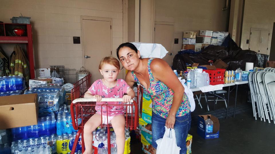 Beth Dougherty and her 2-year-old daughter, Natalee, are staying at the Orange County Emergency Services building in Orange, Texas. Their home was surrounded by floodwaters. (Photo: David Lohr/HuffPost)