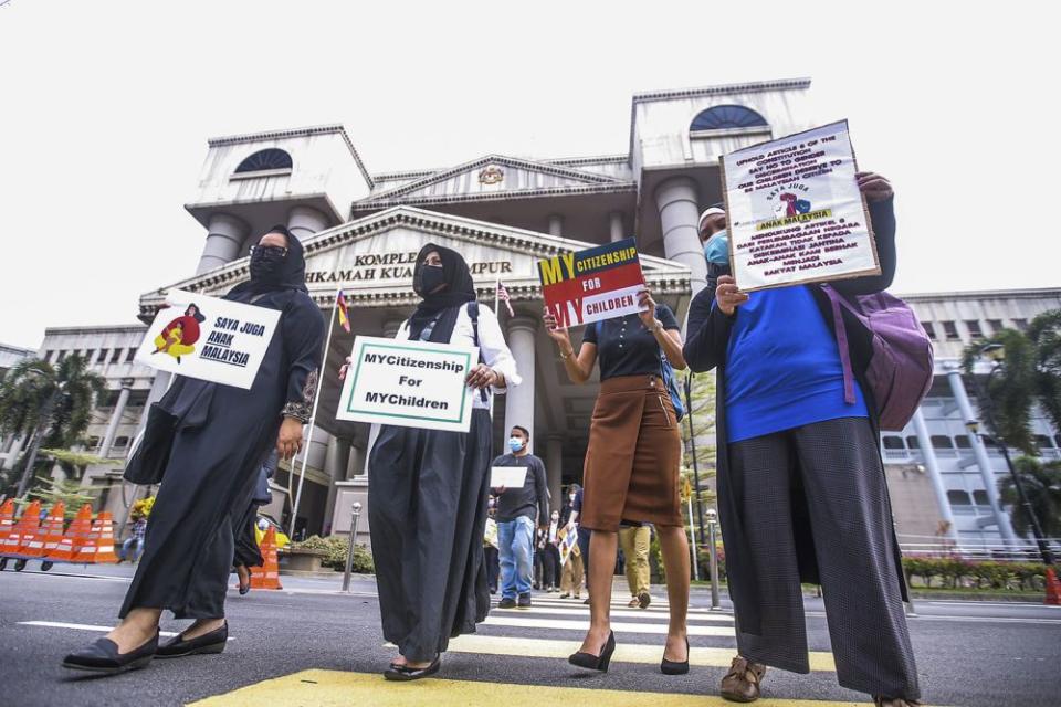 Members of Family Frontiers hold up placards demanding equal citizenship rights for Malaysians at the Kuala Lumpur High Court April 27, 2021. — Picture by Hari Anggara