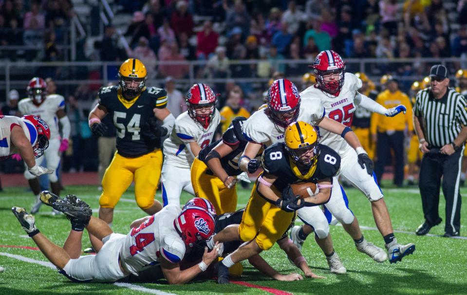 Central Bucks West's Vinny Cherubini (8) dives for extra yardage as he is tackled by Neshaminy in the second quarter of the Neshaminy at Central Bucks West football game Friday, October 07, 2022 at War Memorial Stadium in Doylestown, Pennsylvania. (Photo by William Thomas Cain)