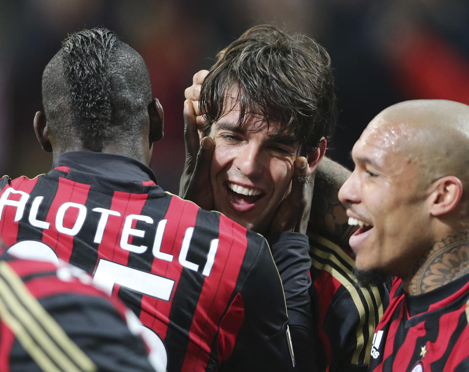 AC Milan Brazilian forward Kaka, center, celebrates with his teammates Mario Balotelli, left, and Nigel de Jong, of the Netherlands, after scoring during the Serie A soccer match between AC Milan and Chievo Verona at the San Siro stadium in Milan, Italy, Saturday, March 29, 2014. (AP Photo/Antonio Calanni)