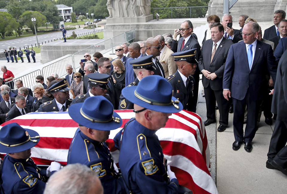 Louisiana Governor John Bel Edwards, right, watches as the casket is brought into the Louisiana State Capital building during an honor procession for former Louisiana Gov. Kathleen Babineaux Blanco, in Baton Rouge, La., Thursday, Aug. 22, 2019. Thursday was the first of three days of public events to honor Blanco, the state's first female governor who died after a years long struggle with cancer.(AP Photo/Michael Democker, Pool)