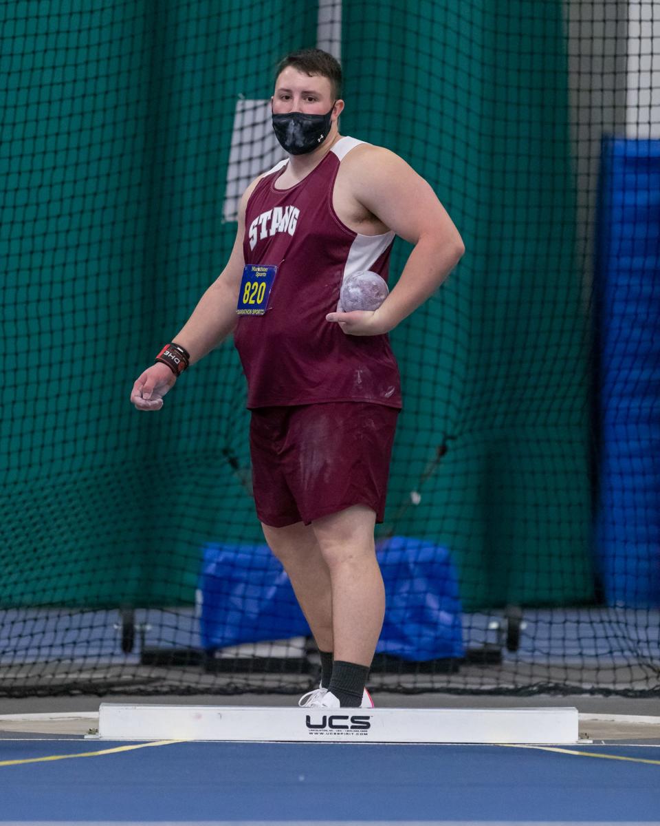 Bishop Stang’s Jacob Cookinham sets his target prior to a throw in the shot put on Thursday at Wheaton College.