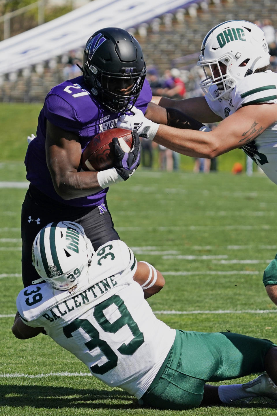 Northwestern running back Anthony Tyus III (27) is tackled by Ohio safety Michael Ballentine (39) and defensive end Bryce Stai during the first half of an NCAA college football game in Evanston, Ill., Saturday, Sept. 25, 2021. (AP Photo/Nam Y. Huh)