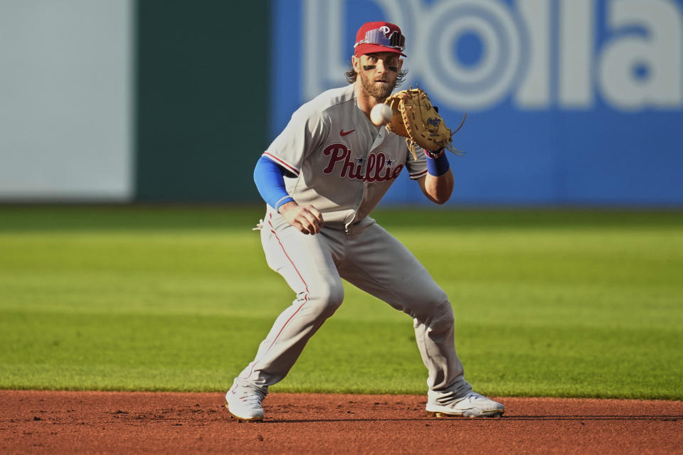 Philadelphia Phillies first baseman Bryce Harper fields a ground ball hit by Cleveland Guardians' Steven Kwan for an out in the first inning of a baseball game Friday, July 21, 2023, in Cleveland. (AP Photo/Sue Ogrocki)