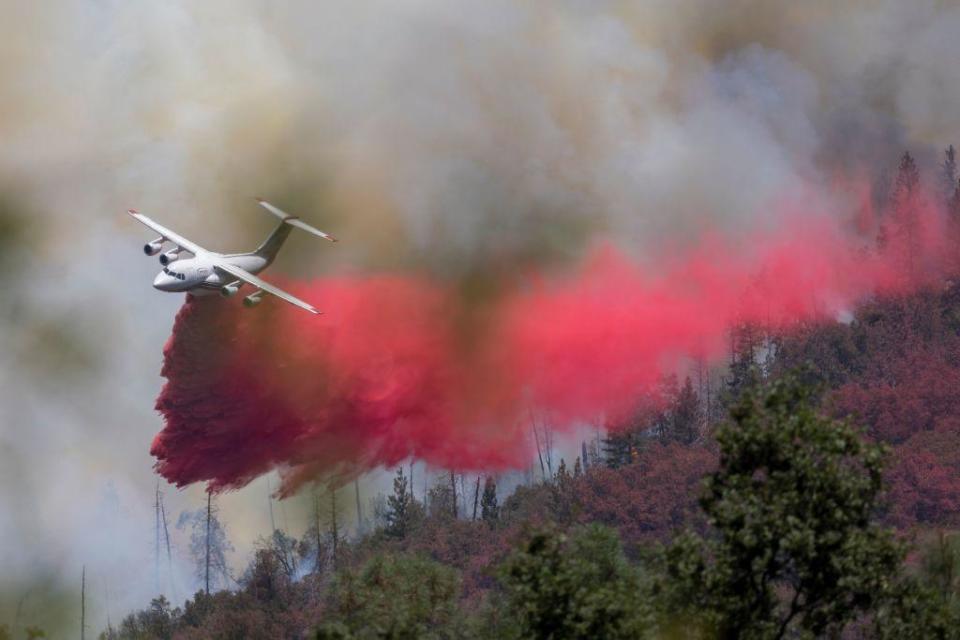 An air tanker makes a fire retardant drop at the Oak Fire near Mariposa, California, on July 24, 2022.  / Credit: DAVID MCNEW/AFP via Getty Images
