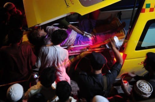 Pakistani rescuers carry an injured worker to an ambulance following the fire at a Karachi garment factory. According to central bank data, the textiles industry contributed 7.4 percent to Pakistan's GDP in 2011 and employed 38 percent of the manufacturing sector workforce. It accounted for 55.6 percent of total exports