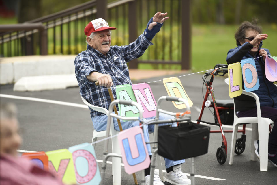 Exeter Township, PA - May 6: Birdsboro Lodge resident Joe Pinder waves at a parade of family members drive by cheering and clapping on Tuesday, May 5, 2020 to cheer up residents unable to see family members due to social distancing during the coronavirus outbreak. (Photo by Lauren A. Little/MediaNews Group/Reading Eagle via Getty Images)