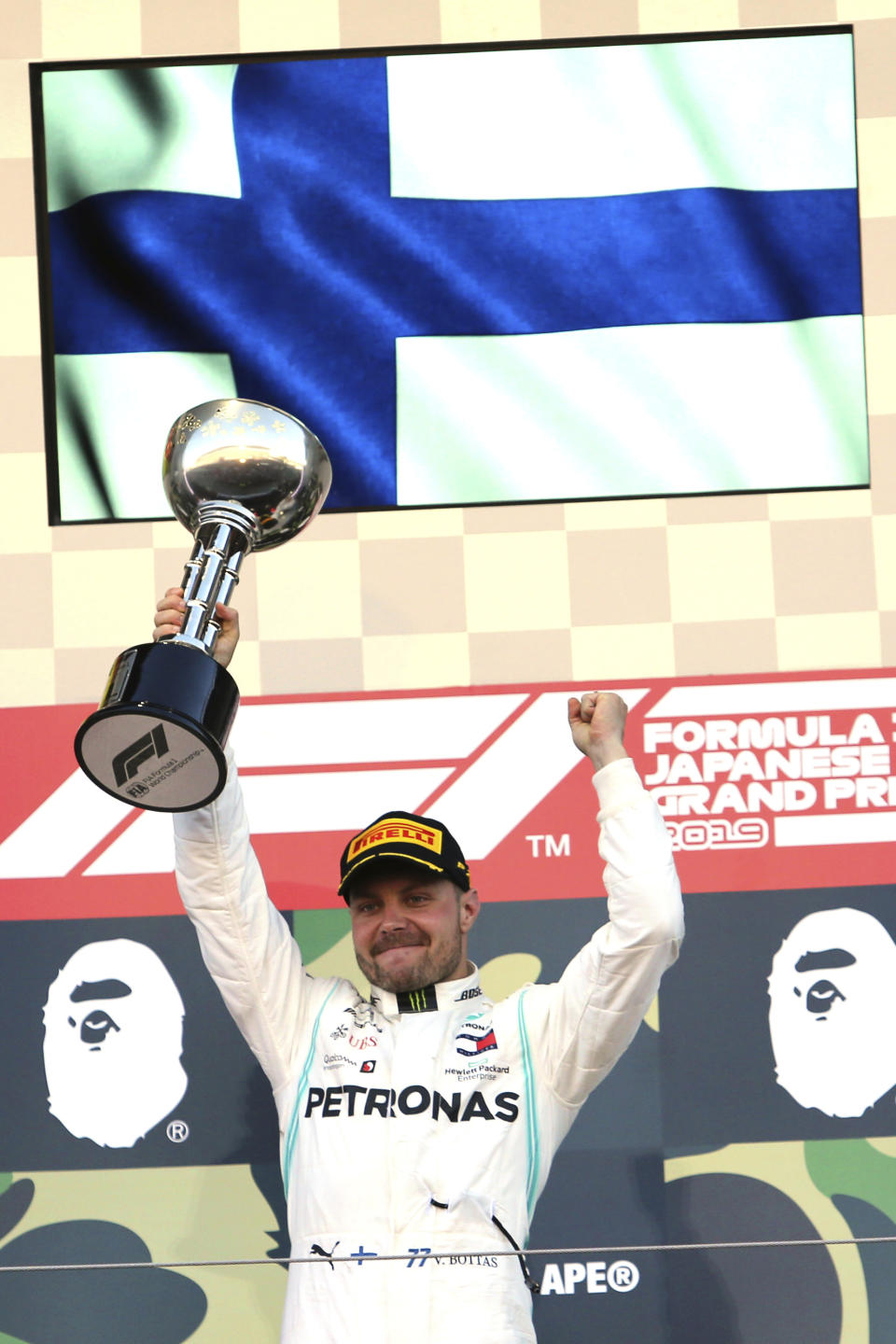 Mercedes driver Valtteri Bottas of Finland raises his trophy on the podium after winning the Japanese Formula One Grand Prix at Suzuka Circuit in Suzuka, central Japan, Sunday, Oct. 13, 2019. (AP Photo/Toru Takahashi)