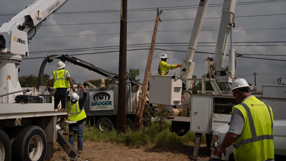 CenterPoint foreign assistance crews work to restore power lines on Thursday in Houston, Texas. - Danielle Villasana/Getty Images