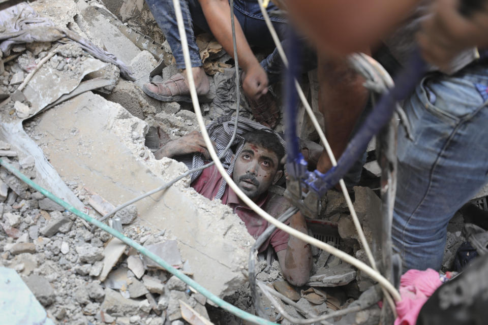 Palestinians rescue a survivor of Israeli bombardment of the Gaza Strip in Nusseirat refugee camp, Tuesday, Oct. 24, 2023. (AP Photo/Ali Mohmoud)