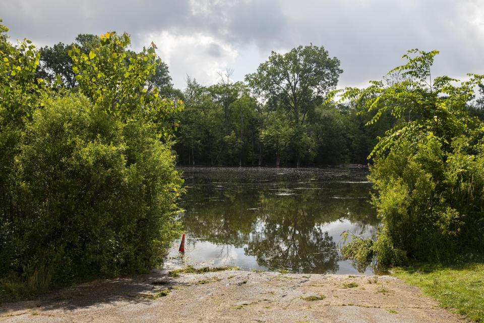 This photo shows the spot on the Kalamazoo River near Verburg Park, Tuesday, June 18, 2019, where police found the bodies of a mother and child inside a submerged vehicle, in Kalamazoo, Mich. Police believe a second child, who is missing, may also have been inside the vehicle when it entered the water late Monday evening. (Joel Bissell/Kalamazoo Gazette via AP)