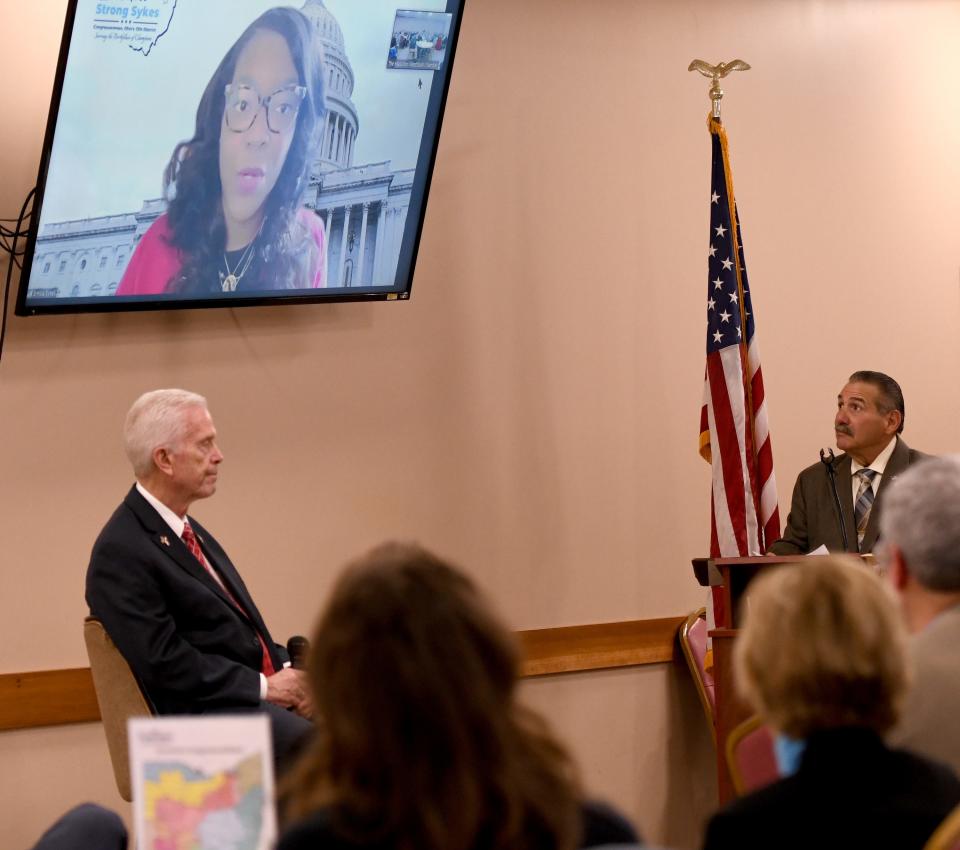 U.S. Rep. BIll Johnson, R-Marietta, (left) and Rep. Emilia Sykes, D-Akron, answer questions Friday morning during the Massillon WestStark Chamber of Commerce annual breakfast. Sykes took part in the event virtually. Also pictured is Fred Horner, president and chief executive officer of Advanced Industrial Roofing in Massillon.