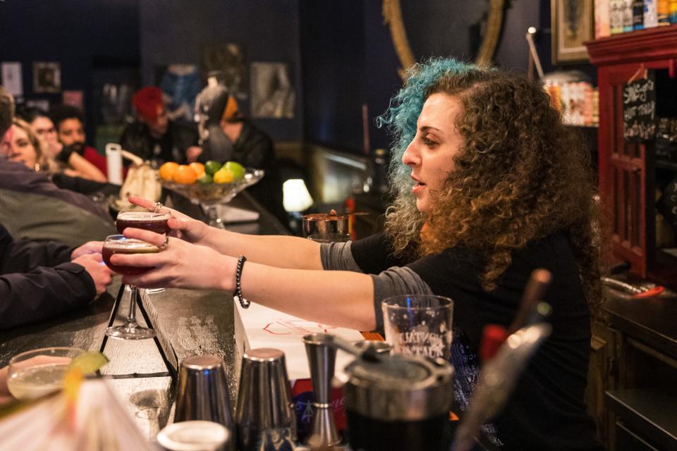 Sierra Margolies serves a non-alcoholic drink to a customer at Hekate Cafe and Elixer Lounge on Jan. 20, 2023, in New York City. Alcohol-free bars, dance parties and “sober curious” events in New York City are experiencing an uptick in popularity with people drinking less and looking for alternative solutions to enjoying nightlife not centered around alcohol.