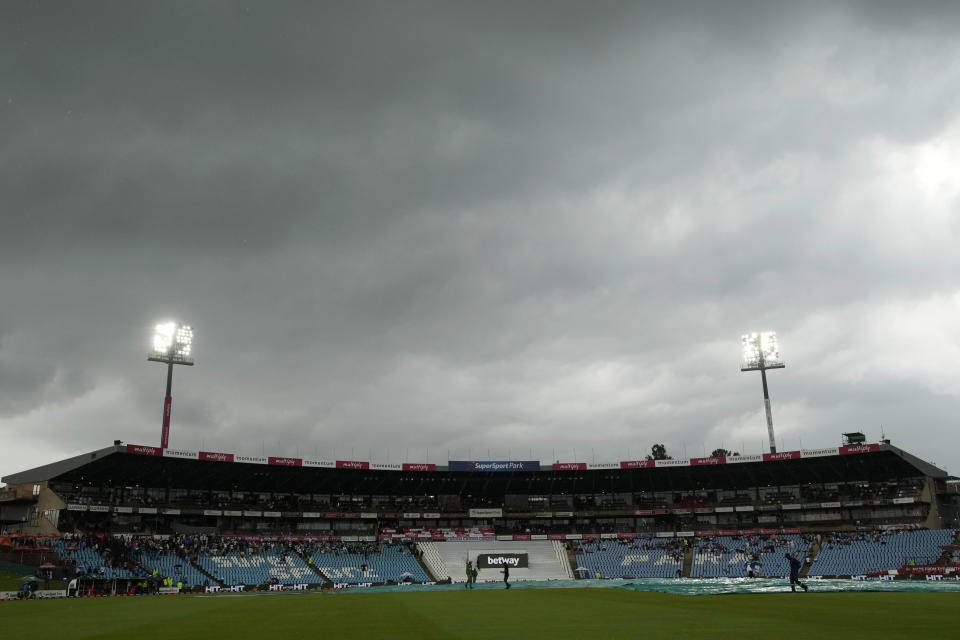 Ground workers pull rain covers as Play has been called off due to bad light during the first day of the Test cricket match between South Africa and India, at Centurion Park, in Centurion, on the outskirts of Pretoria, South Africa, Tuesday, Dec. 26, 2023. (AP Photo/Themba Hadebe)