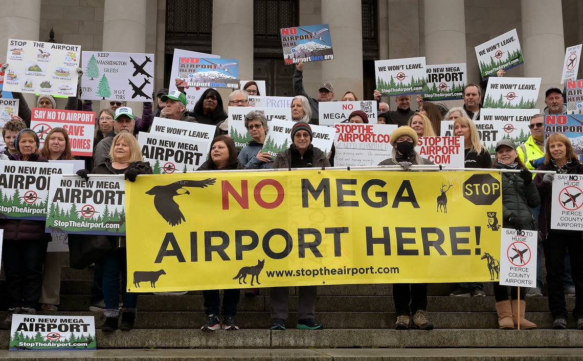 A crowd of 100 people representing Thurston, Pierce, Mason and King counties gathered Wednesday, Jan. 25, 2023, on the state capitol steps in Olympia to protest several potential airport sites targeted for their communities.