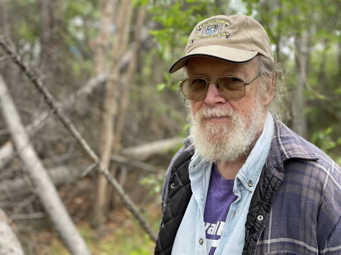 Yellowknifer Walt Humphries says old, dry brush is piling up in parts of Yellowknife, and is a ticking time bomb.  (Robert Holden/CBC - image credit)