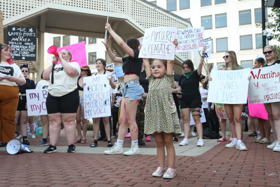Evie Mae Hummer, 3, holds up a handmade sign that reads, "the future is female" during a pro-choice protest at Park Central Square on Monday, July 4, 2022. Community members of all ages rallied in protest of the Supreme Court of the United States' decision to overturn Roe v. Wade on Friday, June 24. Following the protest, the Party for Socialism and Liberation held a march to the federal courthouse.