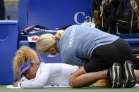 Naomi Osaka is tended to by a trainer during a match against Kaia Kanepi of Estonia, during the National Bank Open tennis tournament in Toronto, on Tuesday, Aug. 9, 2022. (Christopher Katsarov/The Canadian Press via AP)