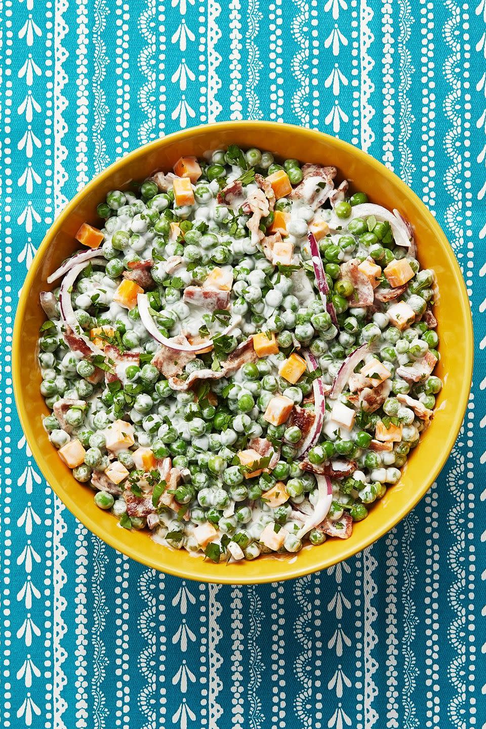 pea salad with ham, onions, and cheddar in yellow bowl