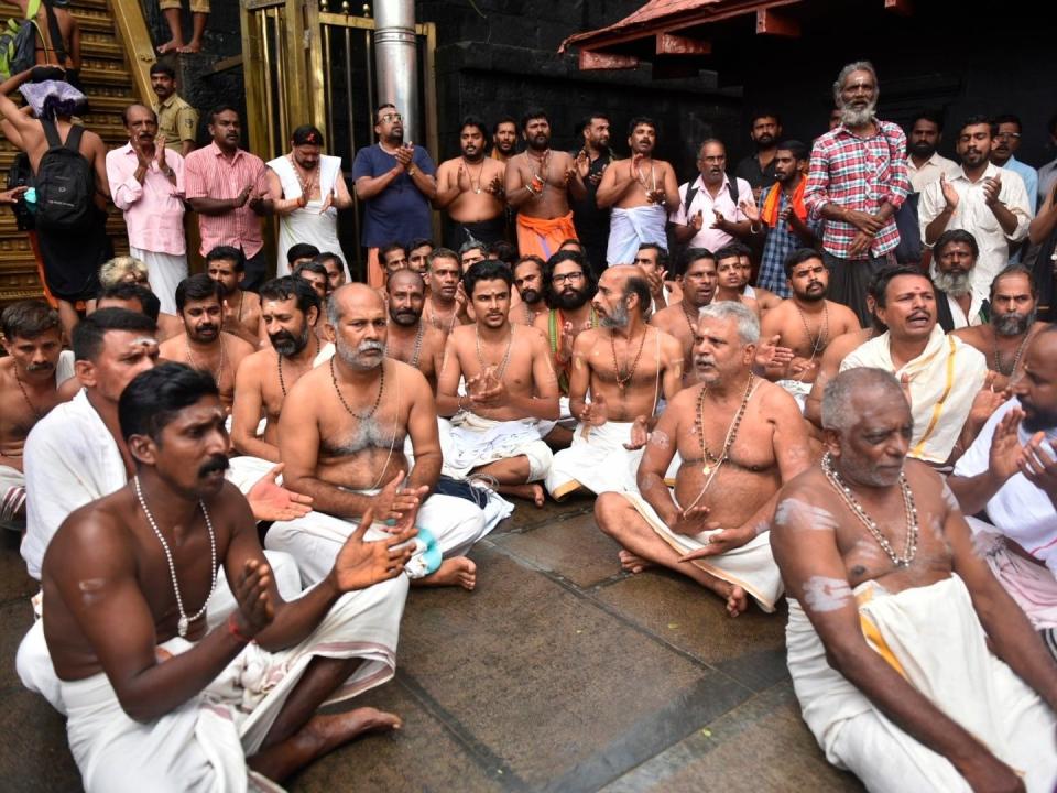 Hindu priests and temple staff sit on a protest against a ruling to let women of menstruating age entering Sabarimala temple: AP