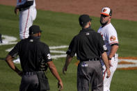 Baltimore Orioles manager Brandon Hyde, right, argues with umpire Dan Iassogna, center, and home plate umpire Jeremie Rehak after the Rehak ejected Hyde during the fourth inning of a baseball game, Thursday, April 8, 2021, on Opening Day in Baltimore. Hyde argued against a call on a pitch from Red Sox's Eduardo Rodriguez that hit Orioles' Rio Ruiz but wasn't awarded first base on a check swing strike. (AP Photo/Julio Cortez)