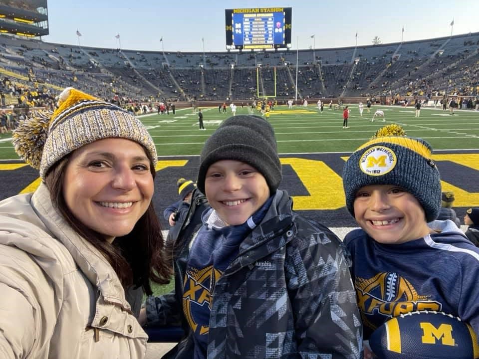 Rosa Everitt, an assistant principal at Lake Orion High School, is seen with her sons Lucas and Aidan, right, at a University of Michigan football game in Ann Arbor on Nov. 6, 2021. The boys attend Oxford Elementary School.
