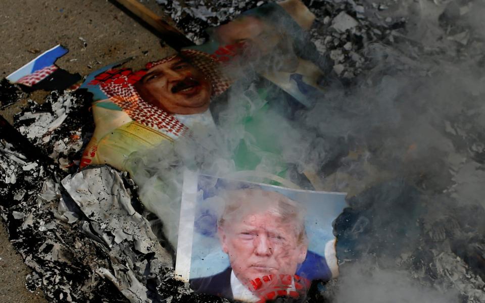 Pictures depicting U.S. President Donald Trump, Bahrain's King Hamad bin Isa Al Khalifa, and Israeli Prime Minister Benjamin Netanyahu are burnt by Palestinians during a protest against the United Arab Emirates and Bahrain's deal with Israel to normalise relations, in Gaza City - Reuters