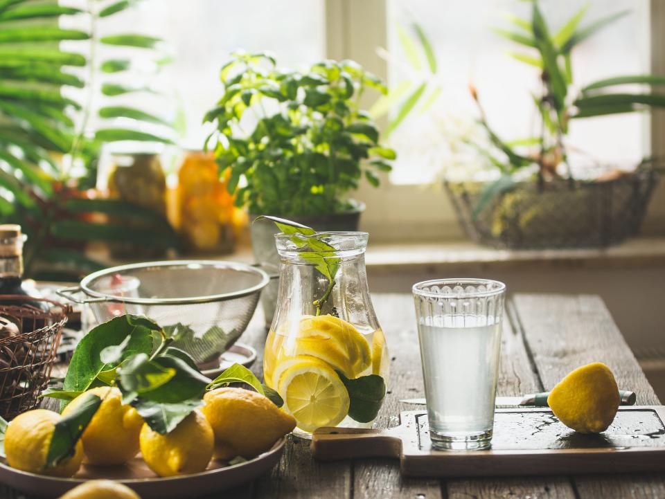 Lemons and lemonade on kitchen table.