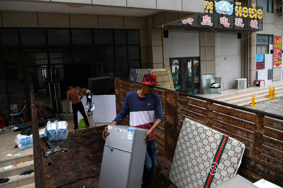 Cambodian workers clear a building in the Chinatown district in Sihanoukville on Sept. 25, 2022. Dozens of casinos sprang up in the city in recent years following Chinese investment, making it a hub for gamblers as well as drawing international crime groups.<span class="copyright">AFP/Getty Images</span>