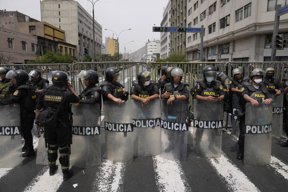 Police block a street that leads to Congress after Peruvian President Pedro Castillo disolved the body on the day lawmakers planned an impeachment vote on him in Lima, Peru, Wednesday, Dec. 7, 2022. Castillo dissolved the nation's Congress on Wednesday and called for new legislative elections, before lawmakers could debate a third attempt to remove him from office. (AP Photo/Martin Mejia)