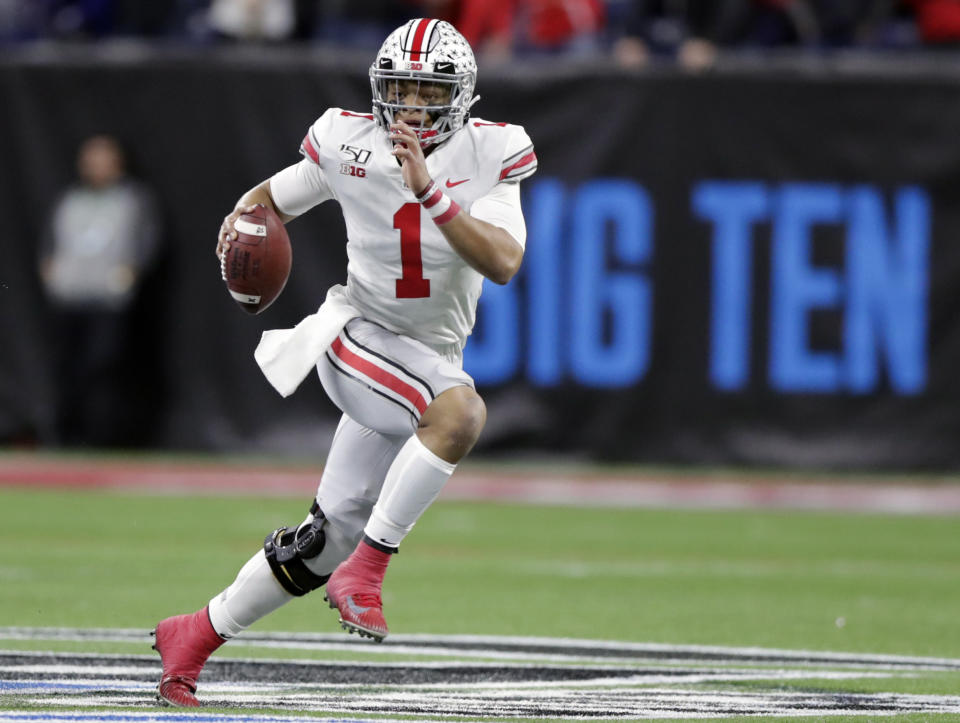 FILE - In this Dec. 7, 2019, file photo, Ohio State quarterback Justin Fields (1) runs with the ball against Wisconsin during the first half of the Big Ten championship NCAA college football game, in Indianapolis. The Big Ten won't play football this fall because of concerns about COVID-19, becoming the first of college sports' power conferences to yield to the pandemic. The move announced Tuesday, Aug. 11, 2020, comes six day after the conference that includes historic programs such as Ohio State, Michigan, Nebraska and Penn State had released a revised conference-only schedule that it hoped would help it navigate a fall season with potential COVID-19 disruptions. (AP Photo/Michael Conroy, File)