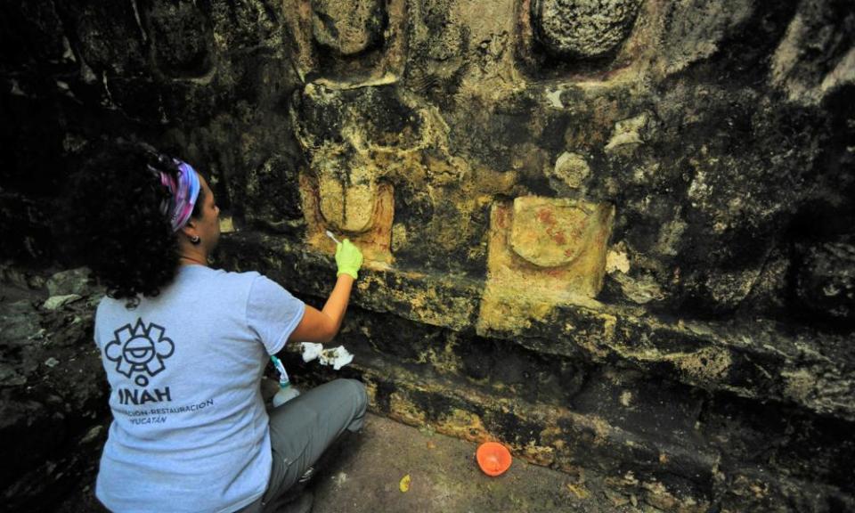 An archaeologist cleans some of the building uncovered in Kulubá