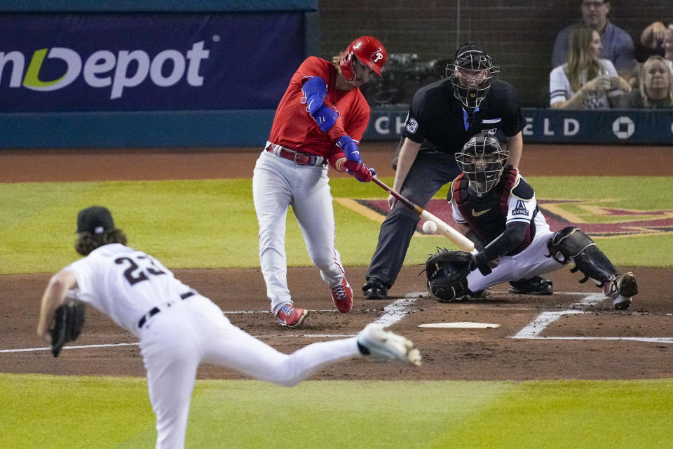 Philadelphia Phillies' Bryson Stott hits RBI-single off Arizona Diamondbacks starting pitcher Zac Gallen during the first inning in Game 5 of the baseball NL Championship Series in Phoenix, Saturday, Oct. 21, 2023. (AP Photo/Rick Scuteri)