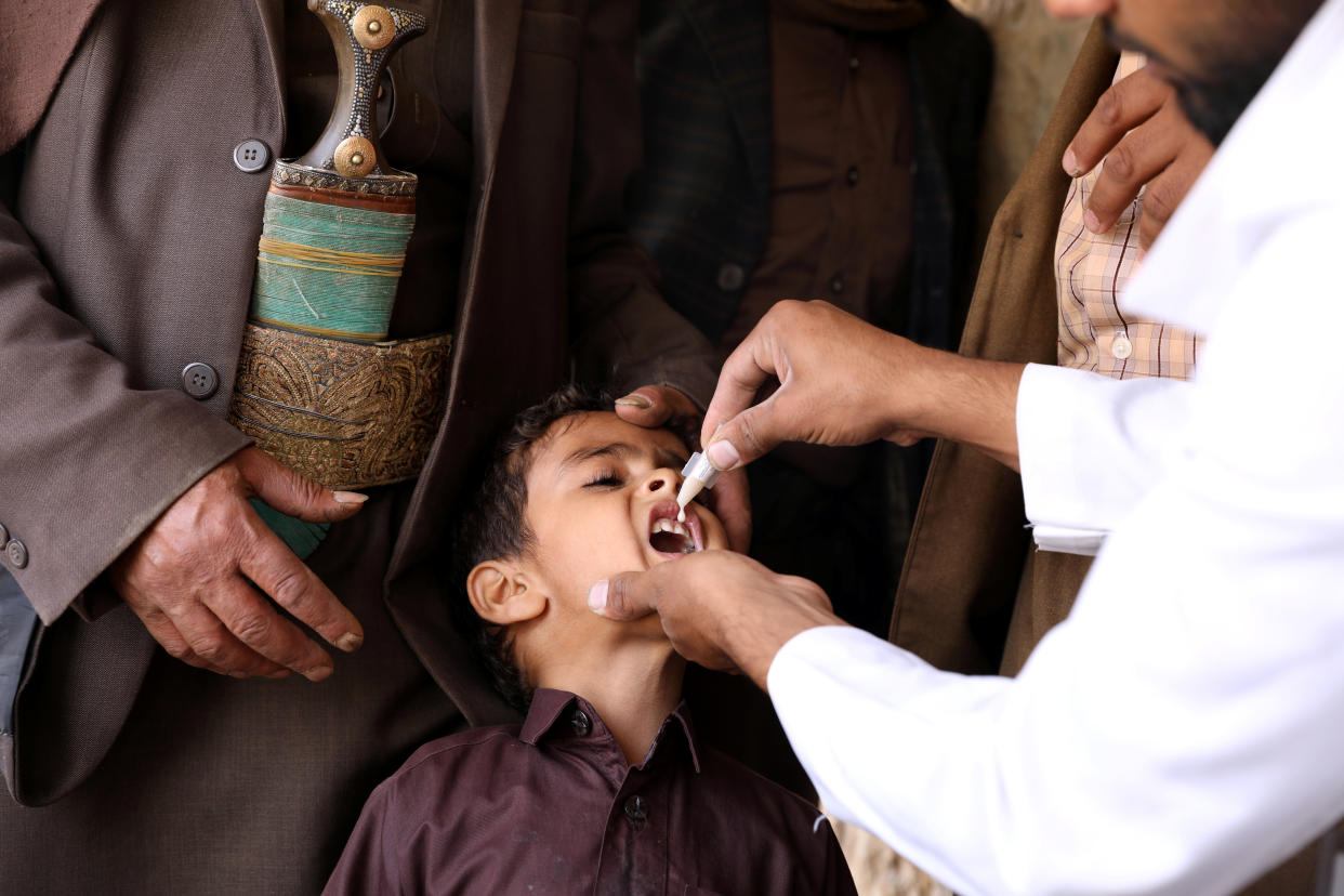 A boy is administered with a cholera vaccine during a house-to-house vaccination campaign in Sanaa, Yemen. (Khaled Abdullah/Reuters)