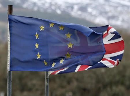 A European Union flag flies in front of a Union flag in Perthshire, Scotland, Britain February 3, 2016. REUTERS/Russell Cheyne