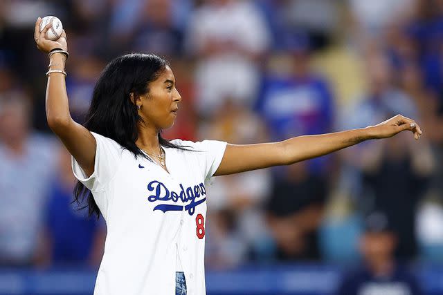 <p>Ronald Martinez/Getty</p> Natalia Bryant throws a ceremonial first pitch