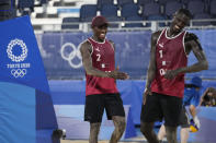 Cherif, Younousse, right, of Qatar, and teammate Ahmed Tijan, celebrate after winning a men's beach volleyball match against Italy at the 2020 Summer Olympics, Wednesday, July 28, 2021, in Tokyo, Japan. (AP Photo/Petros Giannakouris)