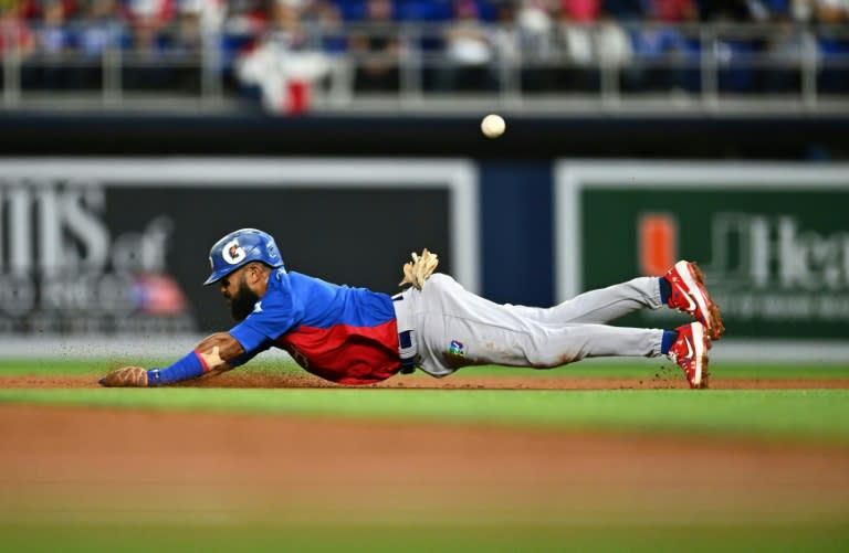 Dominican's outfielder #1 Emilio Bonifacio dives to second base during the Caribbean Series baseball game between the Dominican Republic and Puerto Rico at LoanDepot Park in Miami, Florida, on February 3, 2024. (Chandan Khanna)