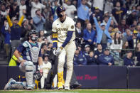 Milwaukee Brewers' Christian Yelich, right, watches his home run during the sixth inning of a baseball game against the Seattle Mariners, Friday, April 5, 2024, in Milwaukee. (AP Photo/Kayla Wolf)