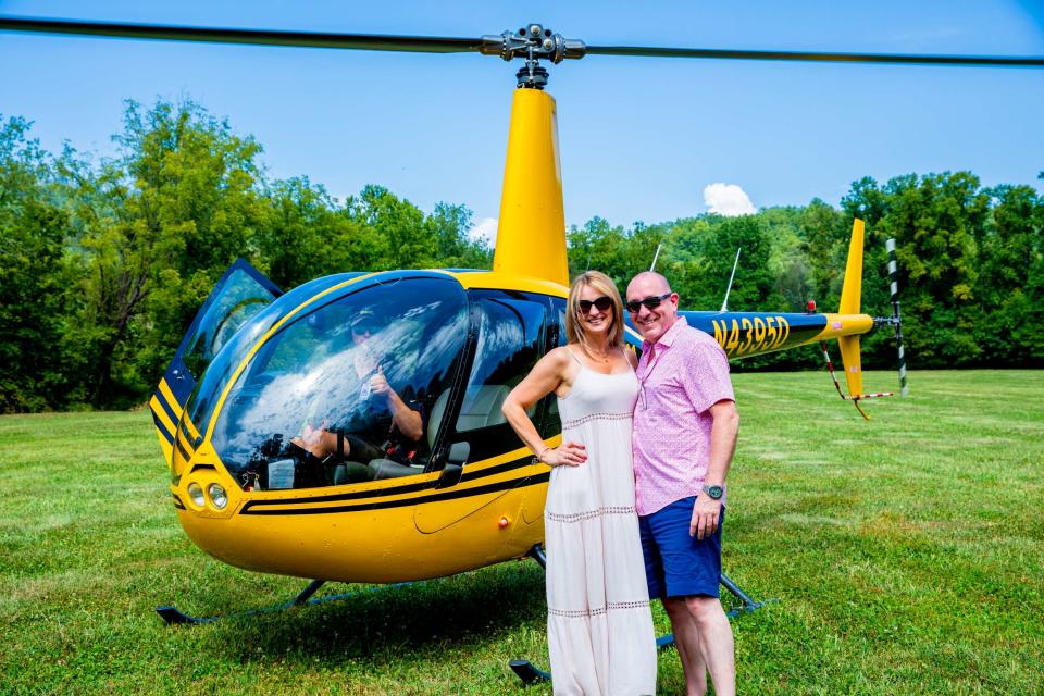 A couple poses after taking one of Souther Williams Vineyard's helicopter tours.
