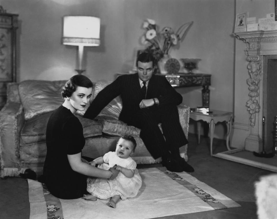 Margaret Sweeny (who later remarried and became the Duchess of Argyll) at home with her husband Charles and their daughter Frances in 1938